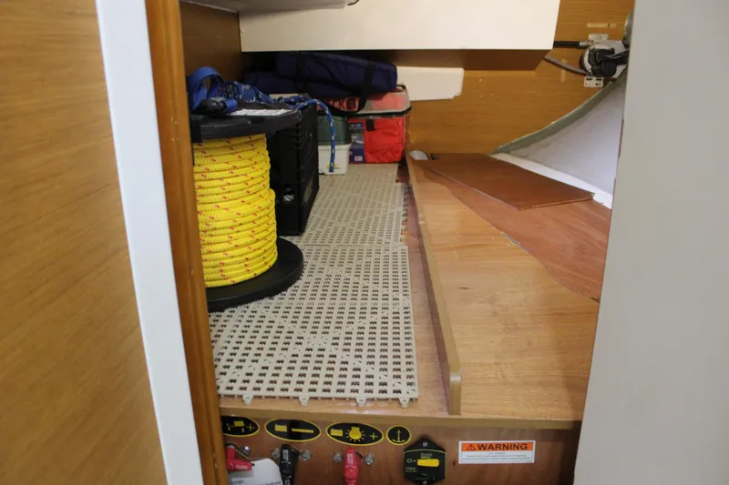 Selkie Yacht Photos Pics Storage area in a 2015 Jeanneau Sun Odyssey 349 sailboat with yellow rope and equipment.