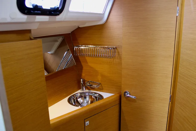 Selkie Yacht Photos Pics 2015 Jeanneau Sun Odyssey 349 yacht interior with wooden finish and compact sink area.
