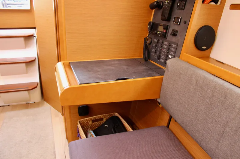 Selkie Yacht Photos Pics Interior of 2015 Jeanneau Sun Odyssey 349 yacht, featuring navigation station and seating area.