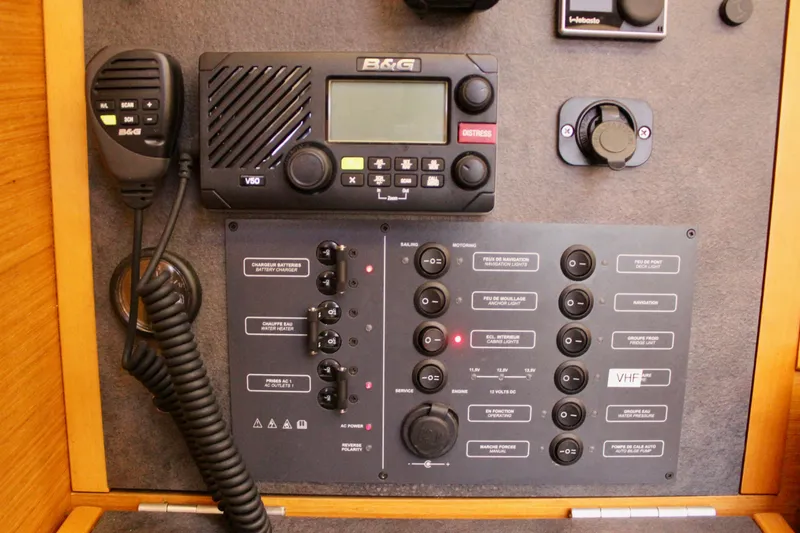 Selkie Yacht Photos Pics Control panel of a 2015 Jeanneau Sun Odyssey 349 sailboat with VHF radio and switches.