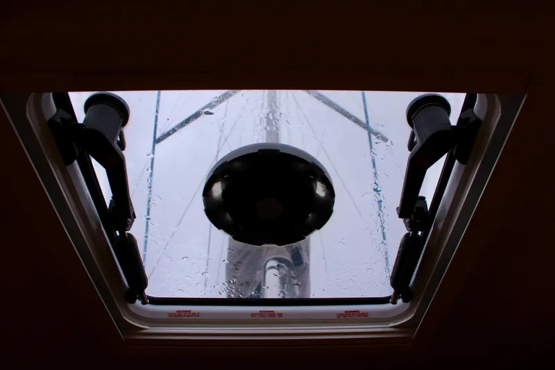 Selkie Yacht Photos Pics Hatch view from Jeanneau Sun Odyssey 349, 2015 model, showing mast and rain droplets.