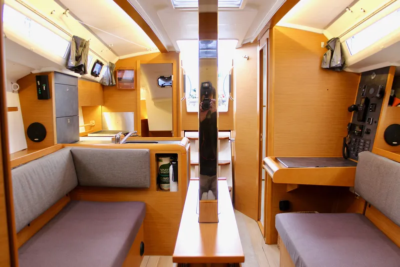 Selkie Yacht Photos Pics Interior of 2015 Jeanneau Sun Odyssey 349 sailboat, featuring cozy seating and modern amenities.