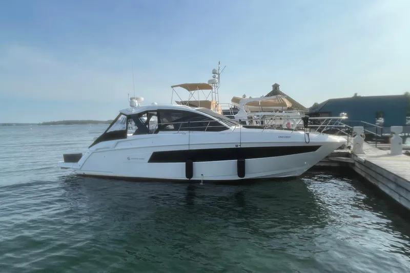  Yacht Photos Pics 2019 Cruisers Yachts 390 Express Coupe docked at marina, side view.