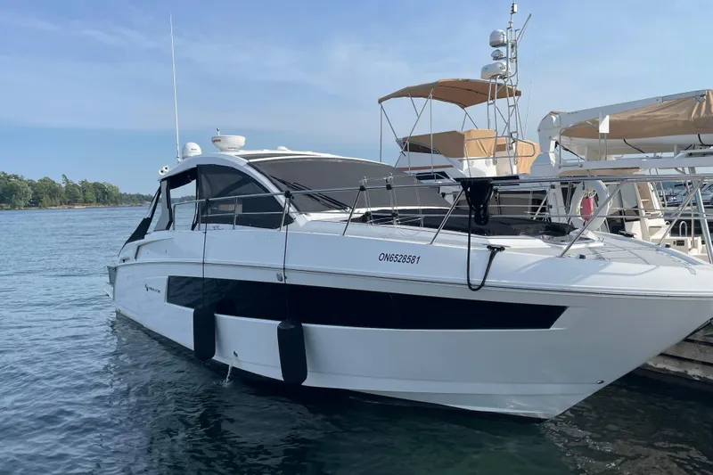 Yacht Photos Pics 2019 Cruisers Yachts 390 Express Coupe docked on a serene lake.
