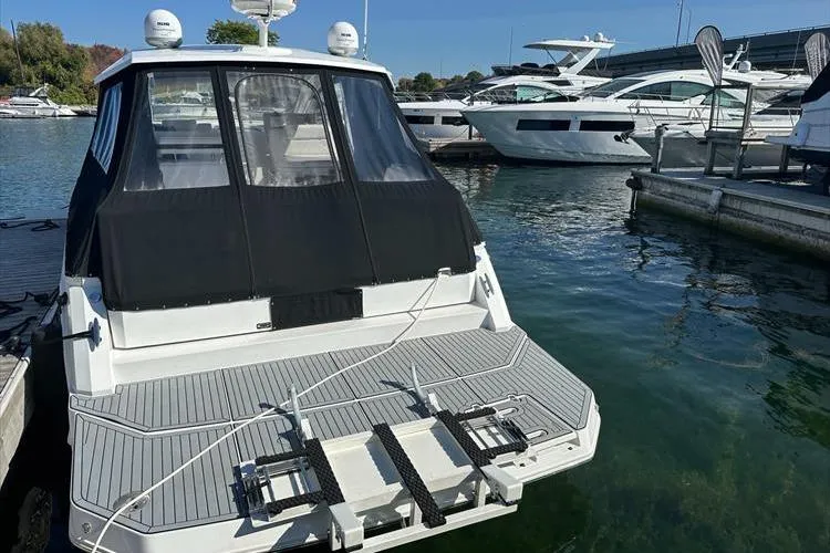  Yacht Photos Pics 2019 Cruisers Yachts 390 Express Coupe docked at marina, rear view.