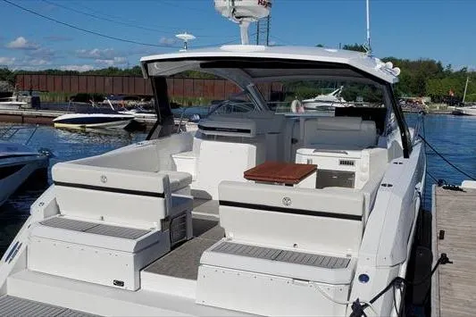  Yacht Photos Pics 2019 Cruisers Yachts 390 Express Coupe docked, showcasing spacious seating and sleek design.