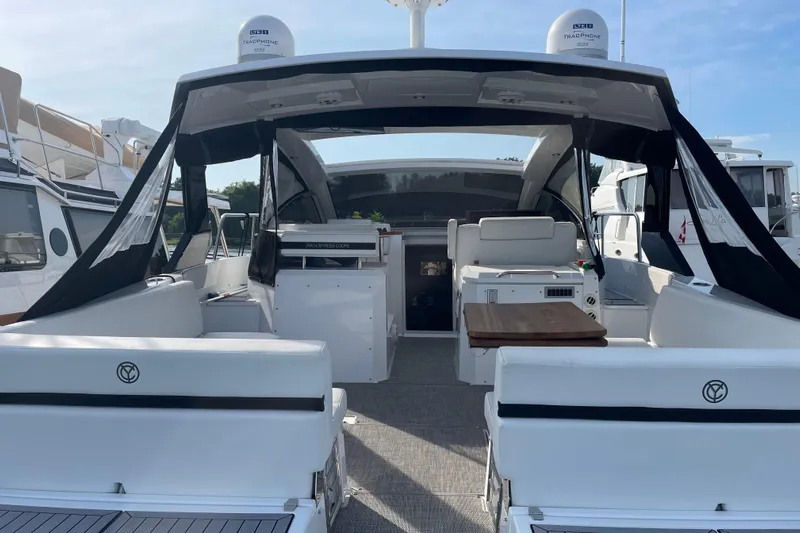  Yacht Photos Pics 2019 Cruisers Yachts 390 Express Coupe interior with seating and table, docked at marina.