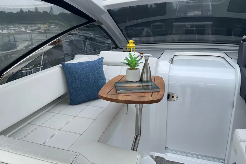  Yacht Photos Pics 2019 Cruisers Yachts 390 Express Coupe interior with white seating and wooden table.