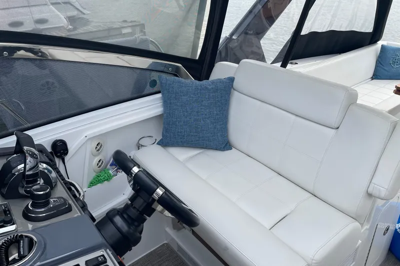  Yacht Photos Pics 2019 Cruisers Yachts 390 Express Coupe interior with white seating and blue cushion.