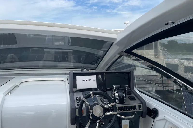  Yacht Photos Pics 2019 Cruisers Yachts 390 Express Coupe helm with Mercury controls and navigation system.