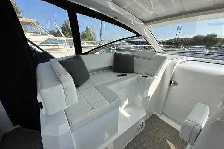  Yacht Photos Pics 2019 Cruisers Yachts 390 Express Coupe interior with white seating and cushions.