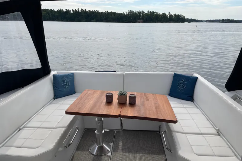  Yacht Photos Pics 2019 Cruisers Yachts 390 Express Coupe interior with lake view, featuring a cozy seating area.