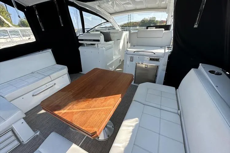  Yacht Photos Pics 2019 Cruisers Yachts 390 Express Coupe interior with white seating and wooden table.
