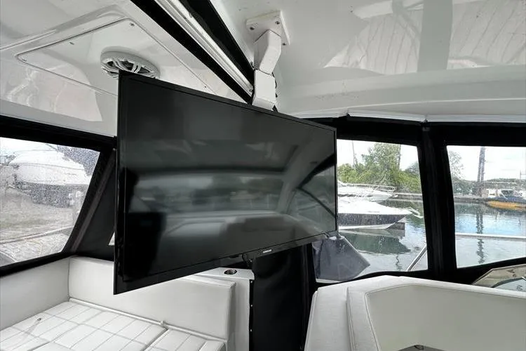  Yacht Photos Pics 2019 Cruisers Yachts 390 Express Coupe interior with mounted TV and marina view.