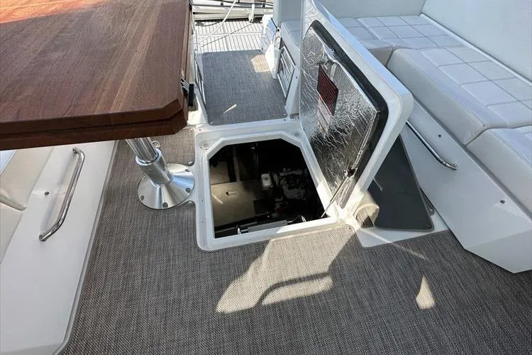  Yacht Photos Pics 2019 Cruisers Yachts 390 Express Coupe interior with open engine hatch and seating area.
