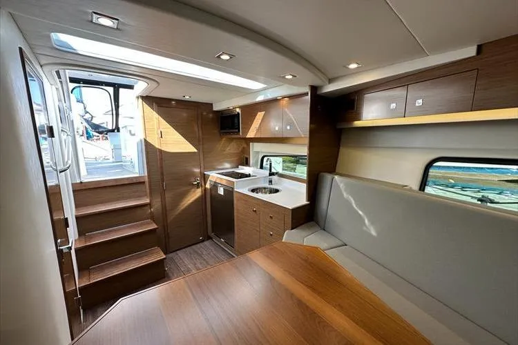  Yacht Photos Pics Interior of 2019 Cruisers Yachts 390 Express Coupe, featuring modern kitchen and seating area.