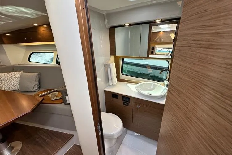  Yacht Photos Pics 2019 Cruisers Yachts 390 Express Coupe interior with modern bathroom and cozy seating area.