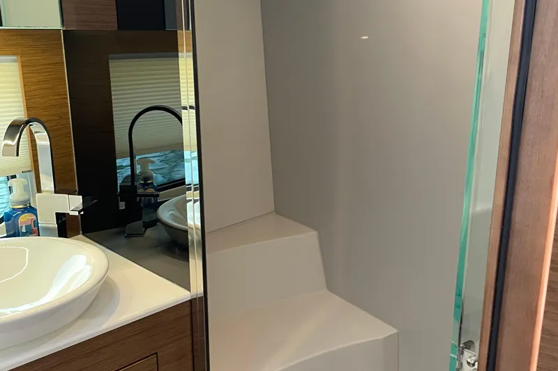  Yacht Photos Pics Modern bathroom interior of 2019 Cruisers Yachts 390 Express Coupe with sleek sink and mirror.