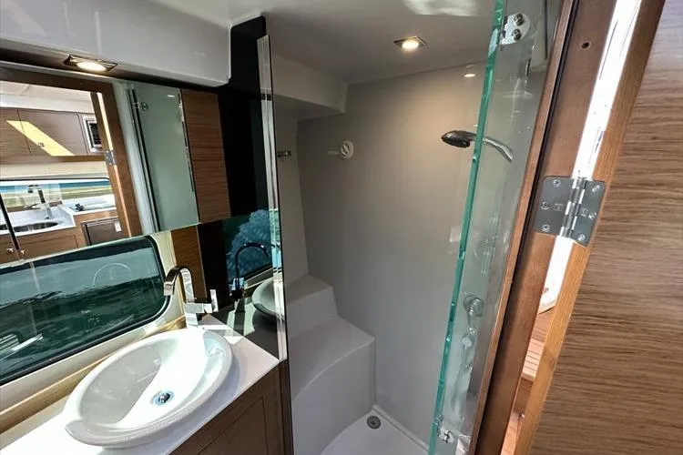  Yacht Photos Pics Luxurious bathroom in 2019 Cruisers Yachts 390 Express Coupe with modern fixtures and glass shower.