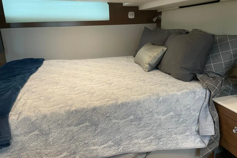  Yacht Photos Pics Luxurious bedroom interior of 2019 Cruisers Yachts 390 Express Coupe with elegant bedding.