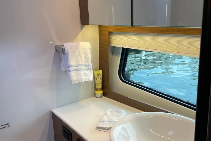  Yacht Photos Pics 2019 Cruisers Yachts 390 Express Coupe bathroom with window, towel, and sink.