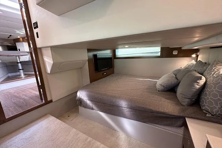  Yacht Photos Pics 2019 Cruisers Yachts 390 Express Coupe interior cabin with bed and TV.
