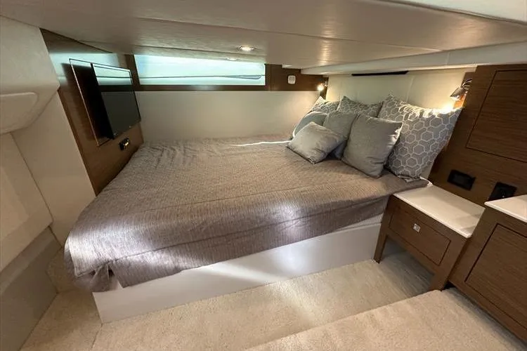  Yacht Photos Pics Luxurious interior cabin of 2019 Cruisers Yachts 390 Express Coupe with cozy bedding.