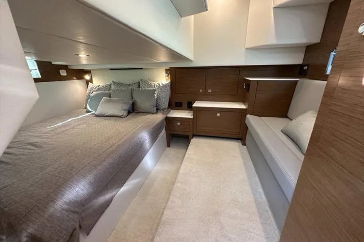  Yacht Photos Pics Luxurious interior of 2019 Cruisers Yachts 390 Express Coupe with elegant bedding and seating.