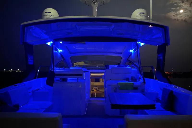  Yacht Photos Pics 2019 Cruisers Yachts 390 Express Coupe with blue interior lighting at night.