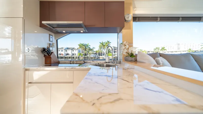 Classy Lady IV Yacht Photos Pics Luxurious kitchen interior of 2020 Monte Carlo Yachts MCY 66 with marble countertops and scenic view.
