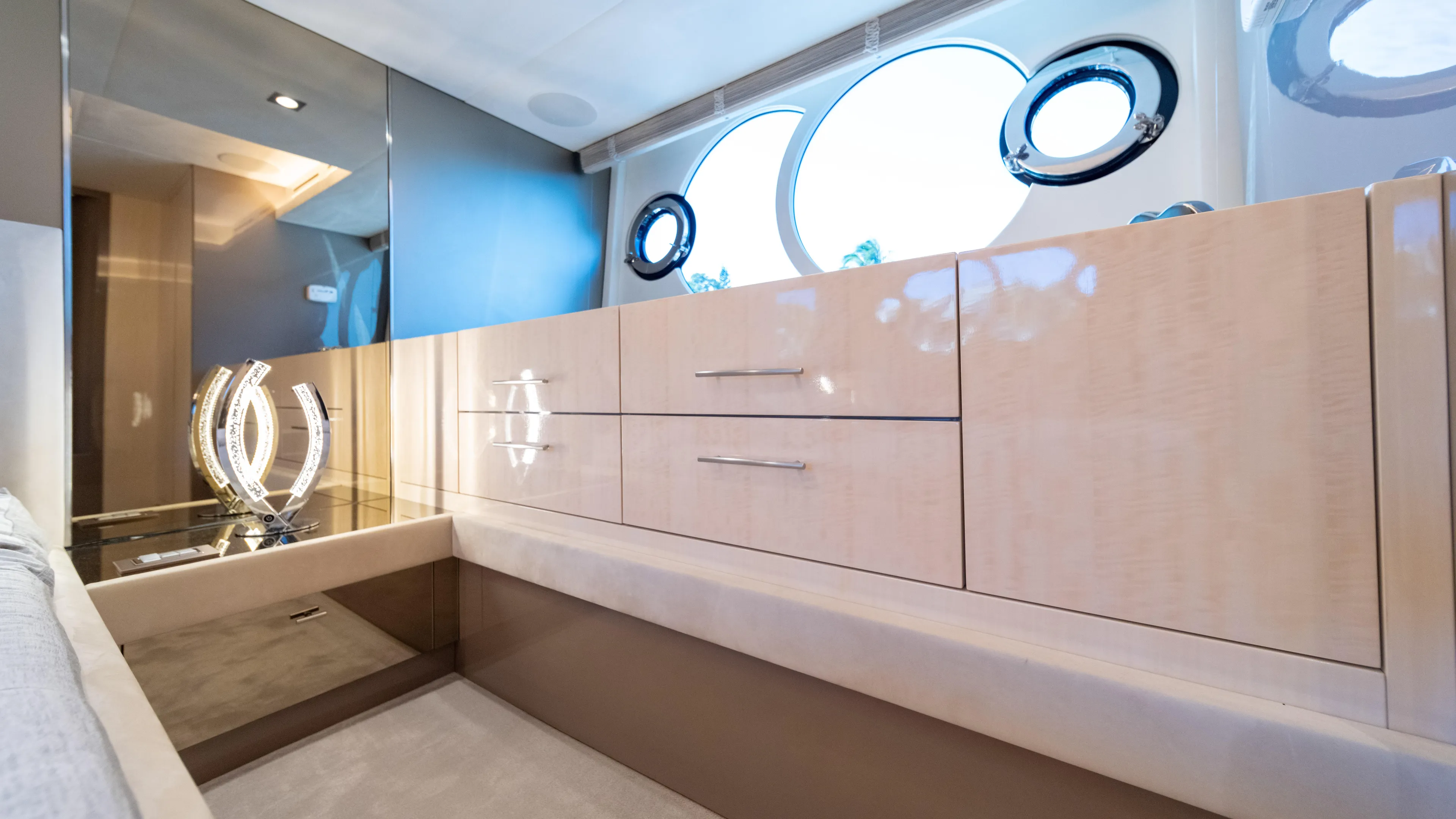 Classy Lady IV Yacht Photos Pics Luxurious interior of 2020 Monte Carlo Yachts MCY 66 with elegant cabinetry and porthole windows.