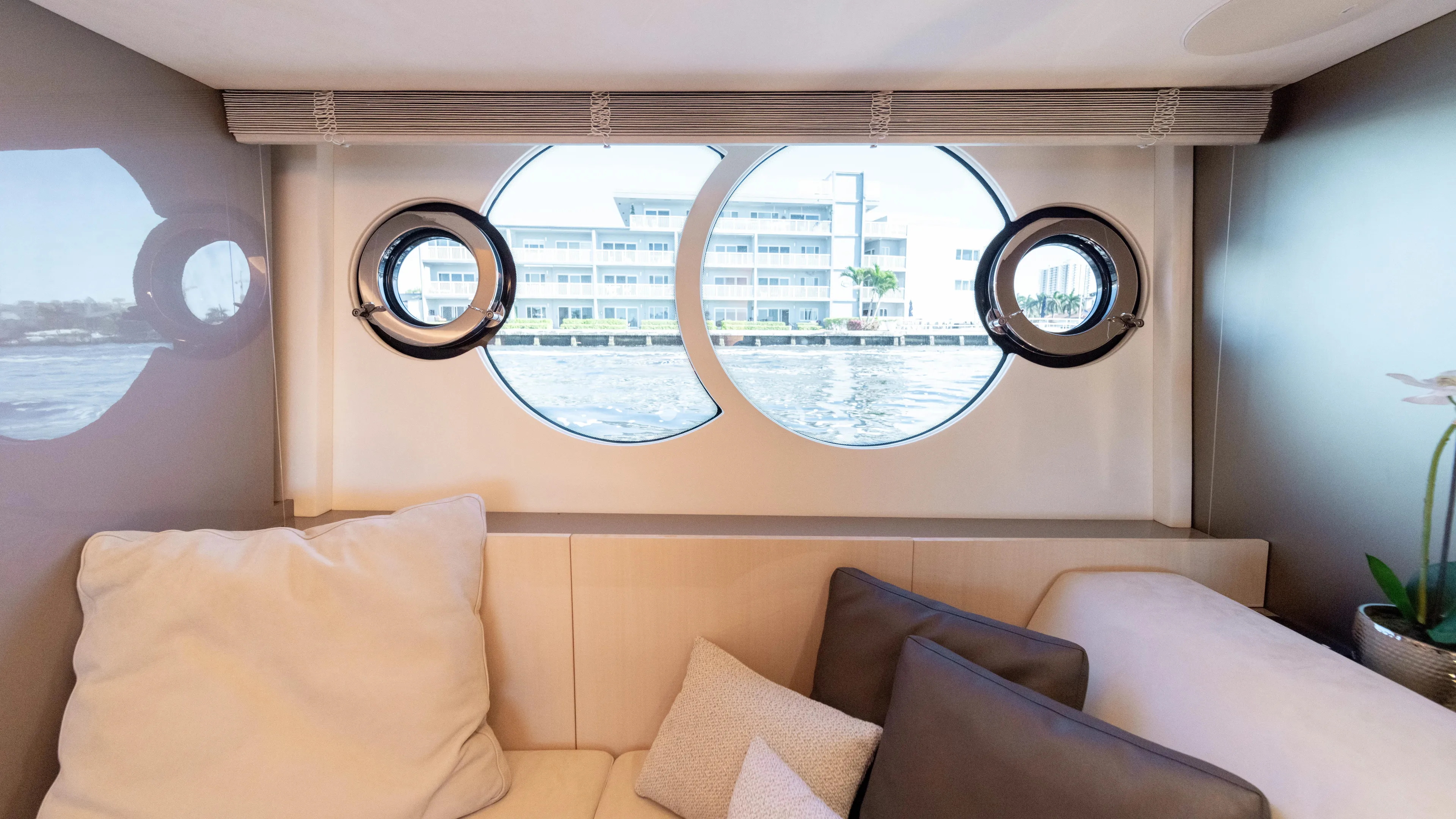 Classy Lady IV Yacht Photos Pics Interior view of 2020 Monte Carlo Yachts MCY 66 with circular windows and cozy seating.