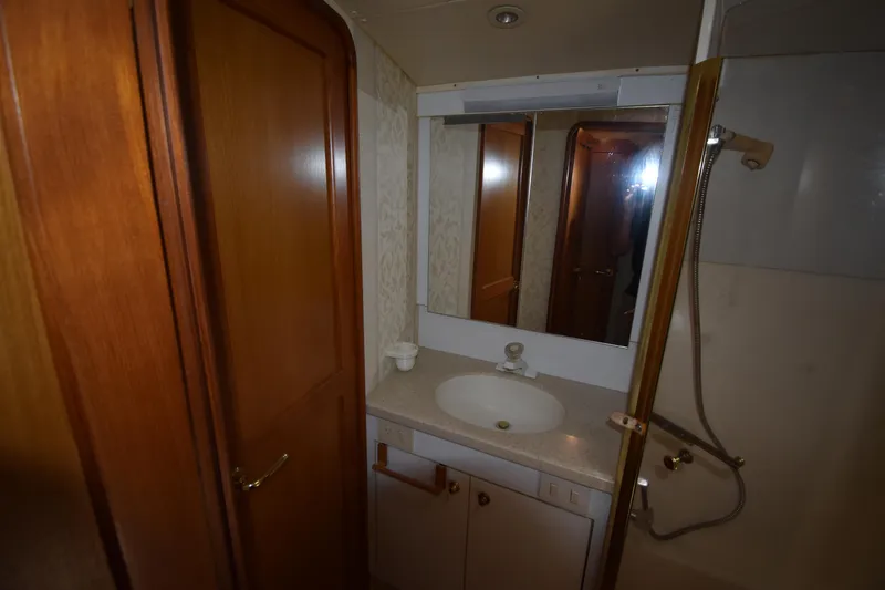  Yacht Photos Pics Bathroom interior of 2003 Ocean Yachts 48 Super Sport with sink, mirror, and shower.