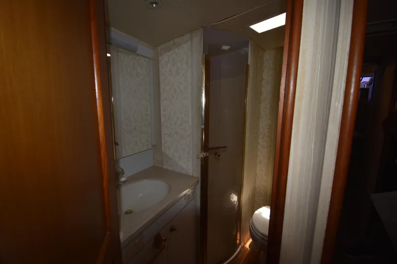  Yacht Photos Pics Bathroom interior of 2003 Ocean Yachts 48 Super Sport with sink, mirror, and shower.