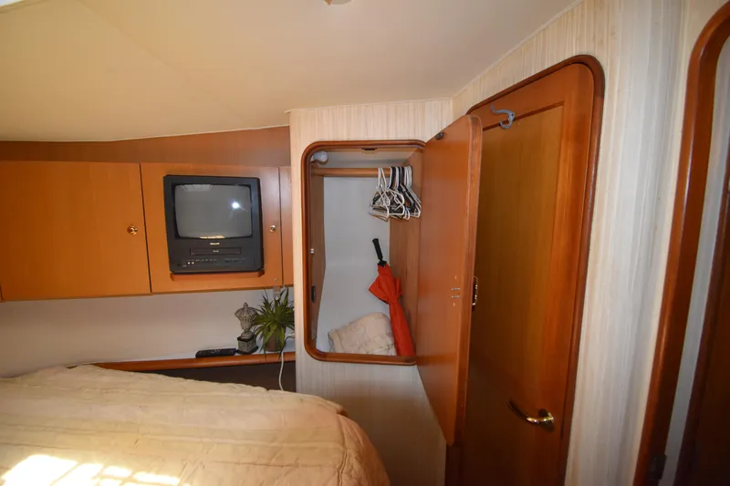  Yacht Photos Pics 2003 Ocean Yachts 48 Super Sport bedroom with TV, closet, and bed.