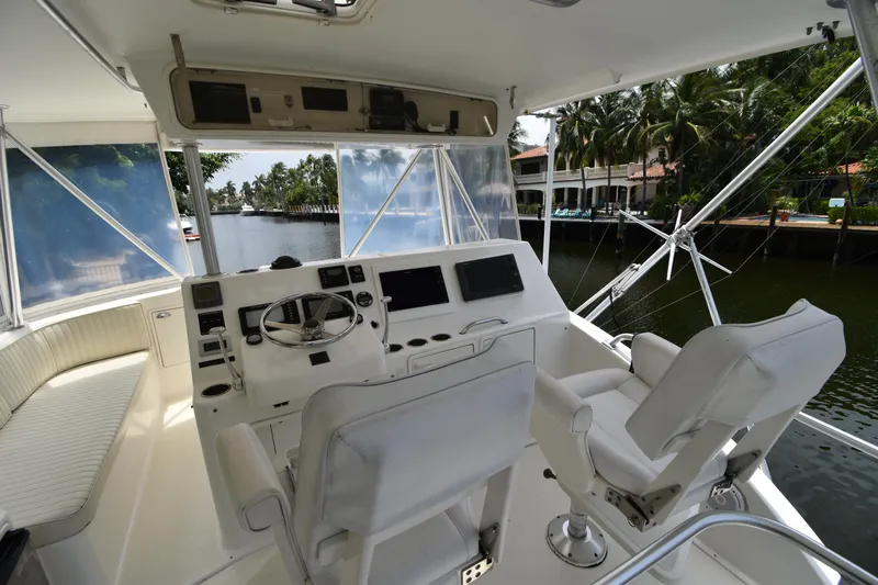  Yacht Photos Pics 2003 Ocean Yachts 48 Super Sport helm station with dual captain chairs and waterfront view.