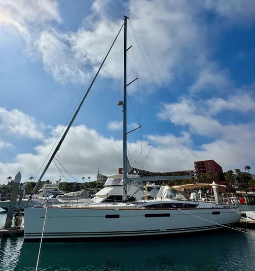 Stella Maris Yacht Photos Pics 2014 Jeanneau 57 sailboat docked at a marina under a partly cloudy sky.