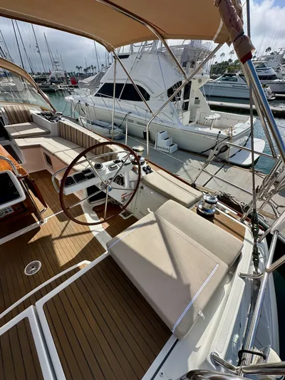Stella Maris Yacht Photos Pics 2014 Jeanneau 57 yacht interior with wooden deck and steering wheel at marina.