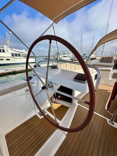 Stella Maris Yacht Photos Pics 2014 Jeanneau 57 yacht helm with wooden deck, docked at marina.