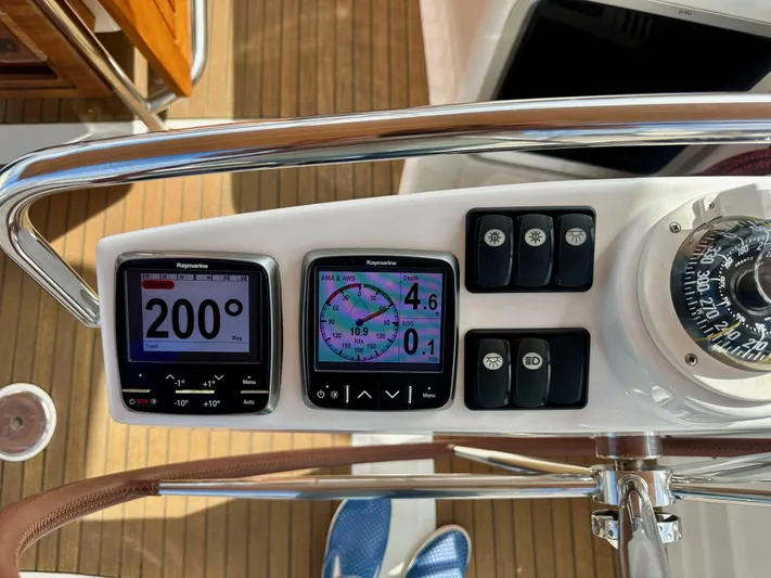 Stella Maris Yacht Photos Pics Control panel of a 2014 Jeanneau 57 yacht with navigation instruments and compass.