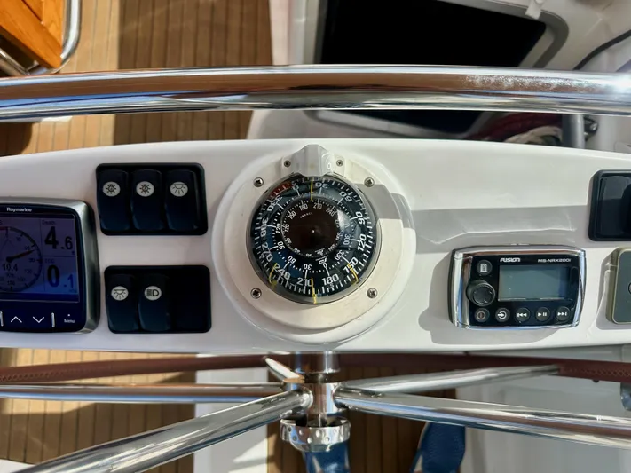 Stella Maris Yacht Photos Pics Jeanneau 57 yacht helm with compass, navigation instruments, and control panel, 2014 model.