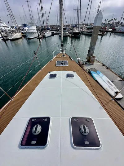Stella Maris Yacht Photos Pics 2014 Jeanneau 57 yacht deck view in marina, showcasing sleek design and moored boats.
