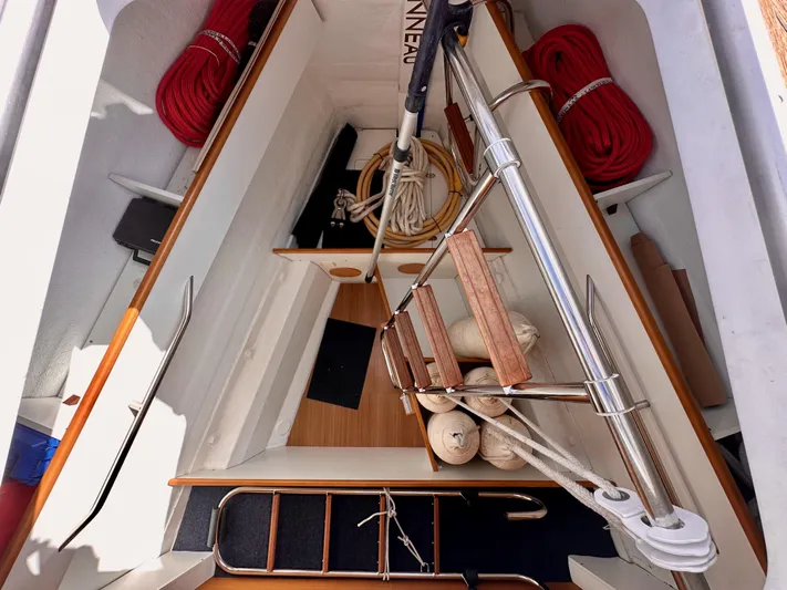Stella Maris Yacht Photos Pics Interior view of 2014 Jeanneau 57 sailboat with ropes and wooden steps.