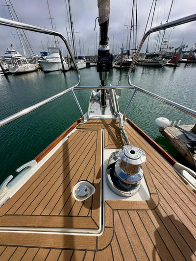 Stella Maris Yacht Photos Pics Bow of 2014 Jeanneau 57 yacht docked in marina, showcasing deck and winch.