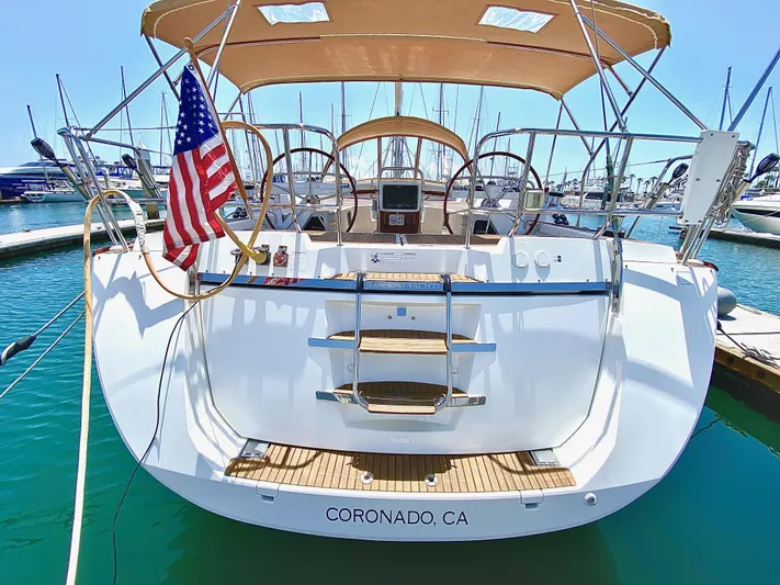 Stella Maris Yacht Photos Pics Jeanneau 57 sailboat, 2014 model, docked in Coronado, CA, with American flag.
