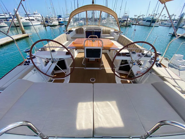 Stella Maris Yacht Photos Pics Luxurious 2014 Jeanneau 57 yacht interior with dual steering wheels in a marina setting.