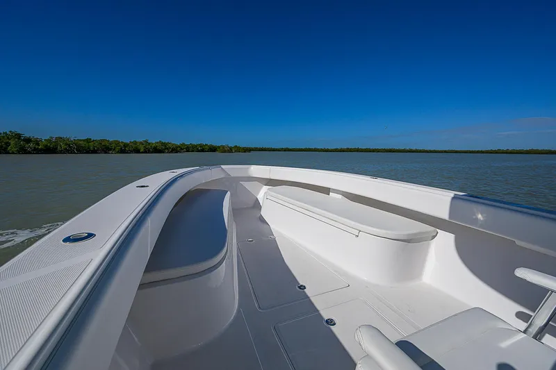 Grand Slam Yacht Photos Pics 2017 Bahama 41 boat deck with seating, cruising on calm waters under clear blue sky.