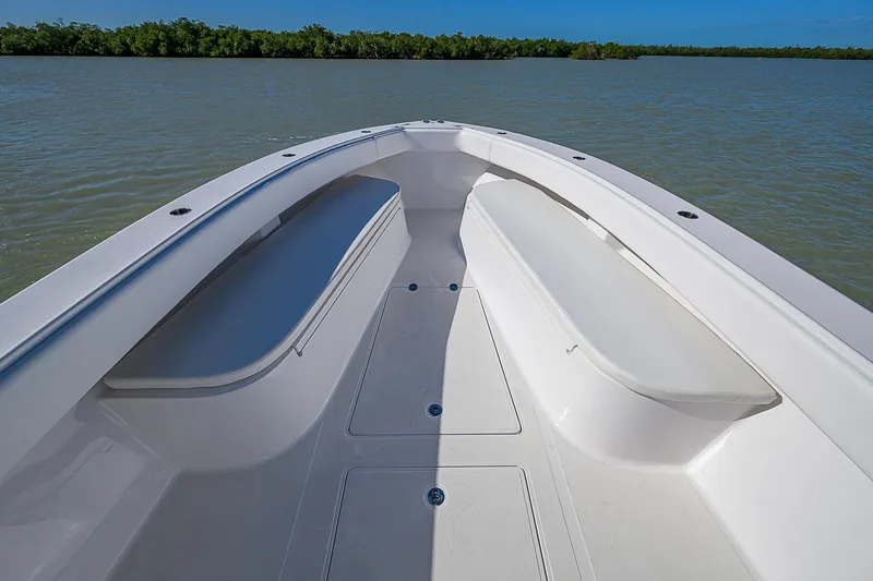 Grand Slam Yacht Photos Pics Bow view of 2017 Bahama 41 boat on calm water, clear sky background.