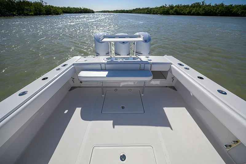 Grand Slam Yacht Photos Pics 2017 Bahama 41 boat deck with seating, overlooking calm waters and lush shoreline.