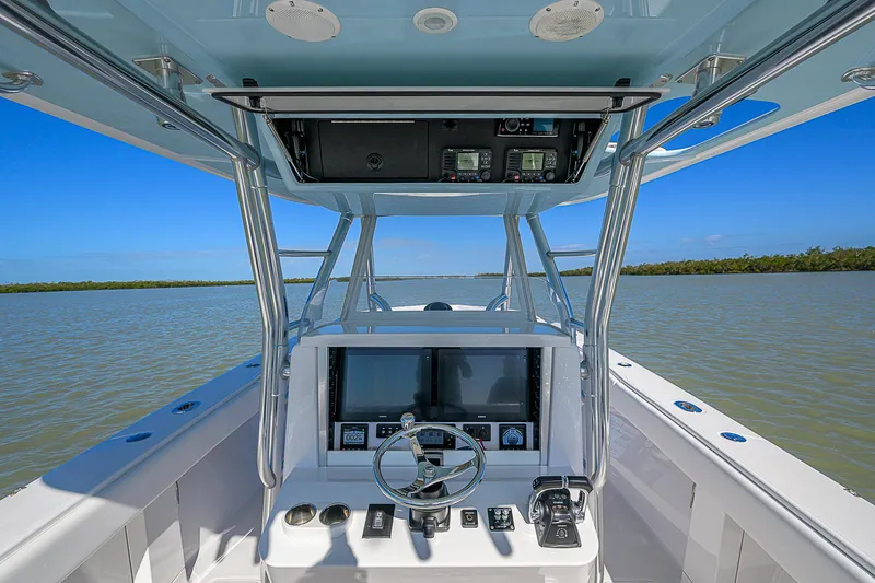 Grand Slam Yacht Photos Pics 2017 Bahama 41 boat helm with dual screens, steering wheel, and controls on open water.